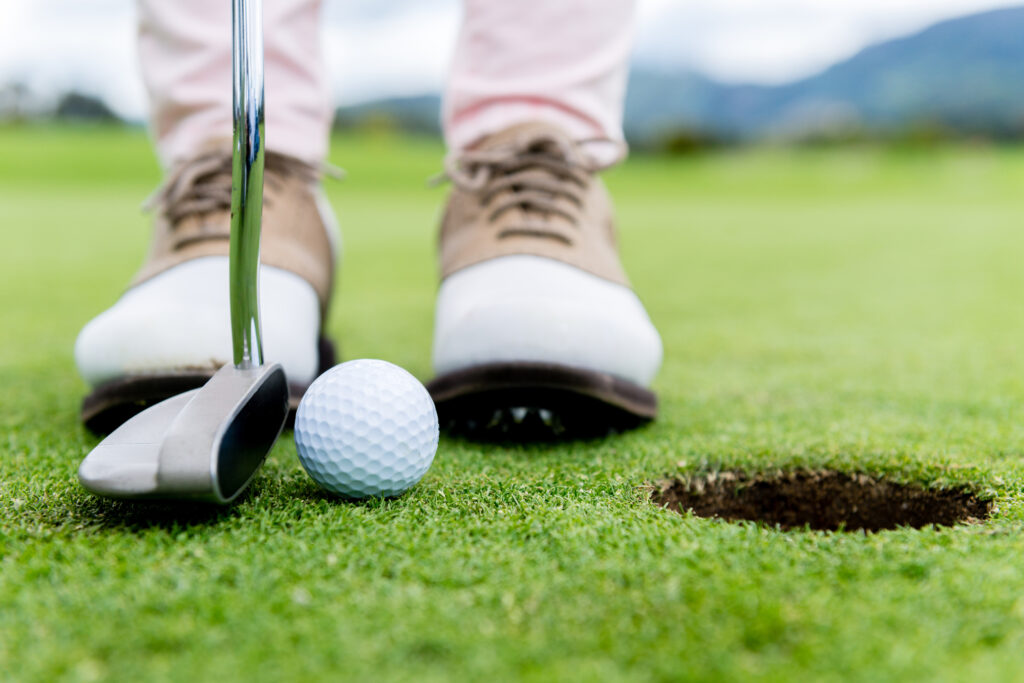 A Golfer with Putter in Position